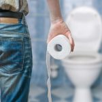 Man suffers from diarrhea holds toilet paper roll