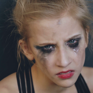 videoblocks-closeup-of-young-teenage-girl-dancer-crying-after-loss-perfomance-sits-on-floor-in-dance-studio-indoors_he2eutwqx_thumbnail-full01