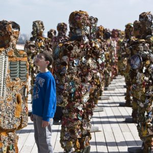 A boy looks at a statue by German artist HA Schult during a preview of the artist’s exhibition at the Ariel Sharon Park near Tel Aviv
